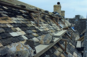 Cost effective roofing repairs Swindon company - reusing old Cotswold stone roof tiles and mixing with new stone tiles, roof repairs company near Cirencester