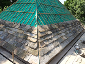 New stone tiled roof using existing tiles